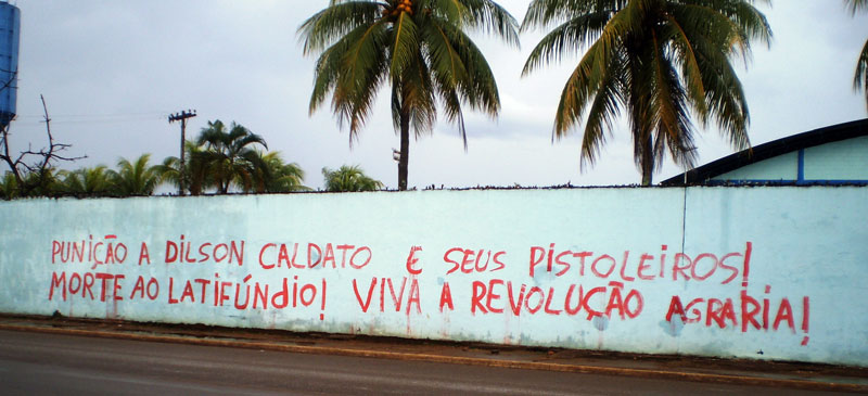 Pichação nos muros de Porto Velho após assassinato dos camponeses Élcio e Gilson.